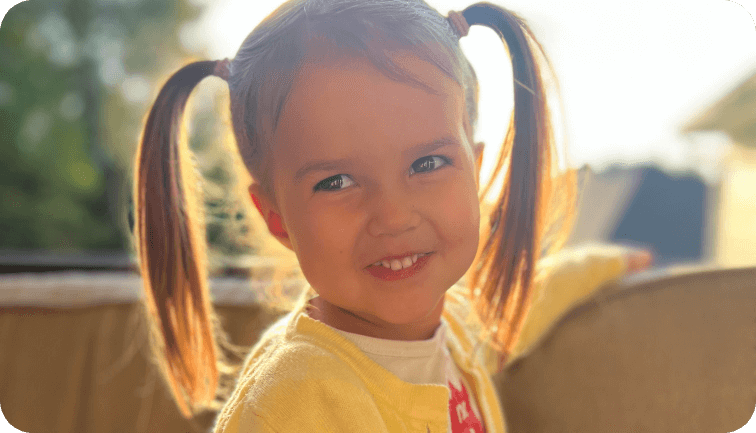 photo of a smiling 5 year old girl with piggy tails